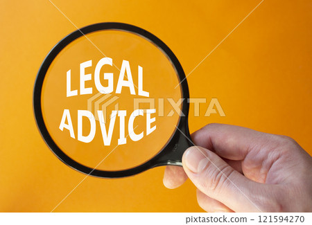 Legal advice symbol. Magnifying glass with words Legal advice. Businessman hand. Beautiful orange background. Business and Legal advice concept. Copy space. Legal advice symbol. Magnifying glass with words Legal advice. Businessman hand. Beautiful orange background. Business and Legal advice concept. Copy space. 121594270