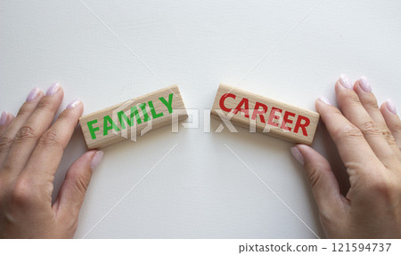 Family or Career symbol. Concept word Family or Career on wooden blocks. Businessman hand. Beautiful white background. Business and Family or Career concept. Copy space Family or Career symbol. Concept word Family or Career on wooden blocks. Businessman hand. Beautiful white background. Business and Family or Career concept. Copy space 121594737