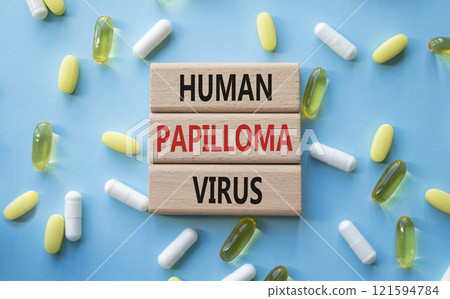 Human Papilloma Virus symbol. Concept word Human Papilloma Virus on wooden blocks. Beautiful blue background with pills. Medicine and Human Papilloma Virus concept. Copy space 121594784