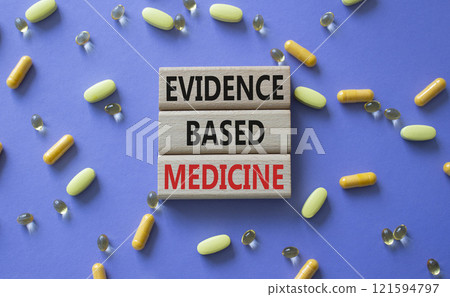 Evidence Based Medicine symbol. Concept word Evidence Based Medicine on wooden blocks. Beautiful purple background with pills. Medicine and Evidence Based Medicine concept. Copy space 121594797