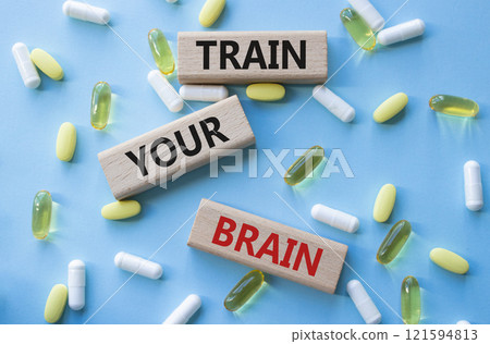Train Your Brain symbol. Concept words Train Your Brain on wooden blocks. Beautiful blue background with pills. Healthcare and Train Your Brain concept. Copy space. Train Your Brain symbol. Concept words Train Your Brain on wooden blocks. Beautiful blue background with pills. Healthcare and Train Your Brain concept. Copy space. 121594813