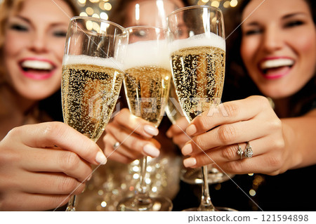 A cheerful celebration featuring close friends clinking champagne glasses in joy and happiness. Social gathering, representing a festive and fun occasion, filled with laughter and sparkling moments. 121594898