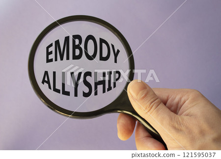 Embody Allyship symbol. Concept word Embody Allyship on magnifying glass. Beautiful purple background. Businessman hand. Business and Embody Allyship concept. Copy space Embody Allyship symbol. Concept word Embody Allyship on magnifying glass. Beautiful purple background. Businessman hand. Business and Embody Allyship concept. Copy space 121595037
