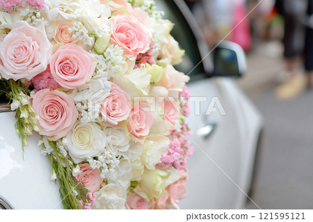 Wedding car interior decorated with flowers. Classic elegant bridal car, old-fashioned car for weddings. Floral wedding decorations for traditional festive celebrations. Love and marriage concept Wedding car interior decorated with flowers. Classic elegant bridal car, old-fashioned car for weddings. Floral wedding decorations for traditional festive celebrations. Love and marriage concept 121595121