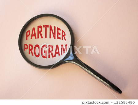 Partner Program symbol. Concept words Partner Program on magnifying glass. Beautiful pink background. Business and Partner Program concept. Copy space. 121595490