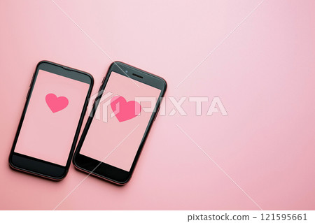 Online dating concept, two smartphones with heart icons, love match, likes, social networking. Dating apps. Popularity, engagement, love, singles looking for relationships 121595661
