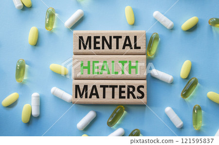 Mental Health Matters symbol. Concept words Mental Health Matters on wooden blocks. Beautiful blue background with pills. Healthcare and Mental Health Matters concept. Copy space. 121595837