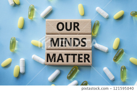 Our Minds Matter symbol. Concept words Our Minds Matter on wooden blocks. Beautiful blue background with pills. Healthcare and Our Minds Matter concept. Copy space. 121595840
