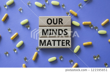 Our Minds Matter symbol. Concept words Our Minds Matter on wooden blocks. Beautiful purple background with pills. Healthcare and Our Minds Matter concept. Copy space. 121595851
