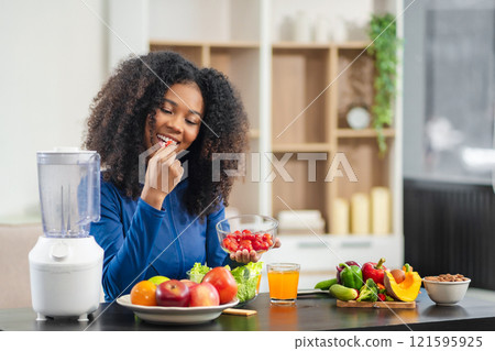 Fit happy black woman enjoys healthy fruit breakfast after yoga training. fitness, nutrition, home lifestyle. Fit happy black woman enjoys healthy fruit breakfast after yoga training. fitness, nutrition, home lifestyle. 121595925