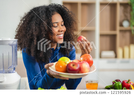 Fit happy black woman enjoys healthy fruit breakfast after yoga training. fitness, nutrition, home lifestyle. Fit happy black woman enjoys healthy fruit breakfast after yoga training. fitness, nutrition, home lifestyle. 121595926