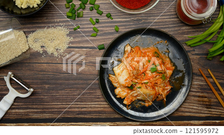 Top view traditional Korean Kimchi served on a plate. Korean cuisine and traditional side dish concept Top view traditional Korean Kimchi served on a plate. Korean cuisine and traditional side dish concept 121595972