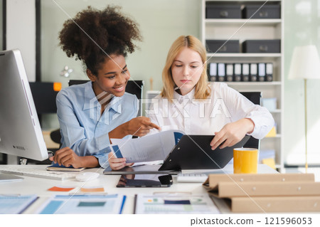 Diverse professionals collaborate on project analysis with financial graphs. Strategic teamwork and insights drive company growth and success. Diverse professionals collaborate on project analysis with financial graphs. Strategic teamwork and insights drive company growth and success. 121596053