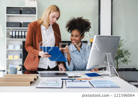 Diverse professionals collaborate on project analysis with financial graphs. Strategic teamwork and insights drive company growth and success. Diverse professionals collaborate on project analysis with financial graphs. Strategic teamwork and insights drive company growth and success. 121596064