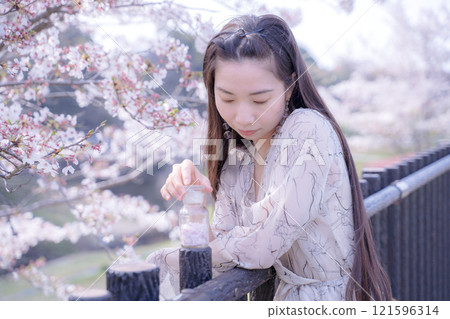 Young woman posing under the cherry tree Young woman posing under the cherry tree 121596314