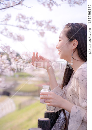Young woman posing under the cherry tree Young woman posing under the cherry tree 121596382