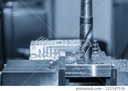 The drilling process on NC milling machine in the light blue scene. The drilling process on NC milling machine in the light blue scene. 121597516