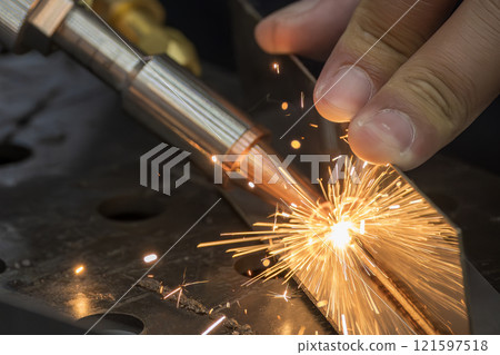 Close up scene the laser welding process by hand held laser welding machine. Close up scene the laser welding process by hand held laser welding machine. 121597518