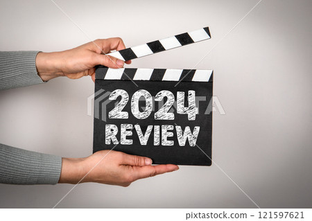 2024 Review Concept. Female hands holding movie clapper 2024 Review Concept. Female hands holding movie clapper 121597621