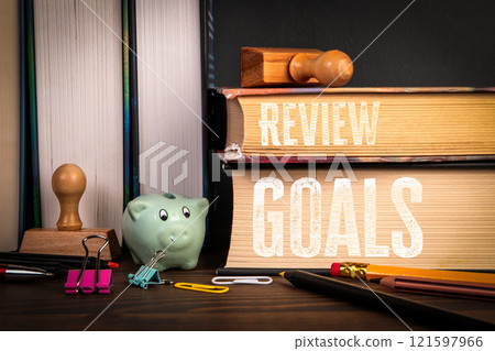 REVIEW and GOALS Concept. Stack of books on a wooden shelf 121597966