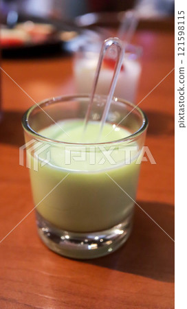 Matcha tea green jelly pudding dessert in a small glass. Matcha tea green jelly pudding dessert in a small glass. 121598115