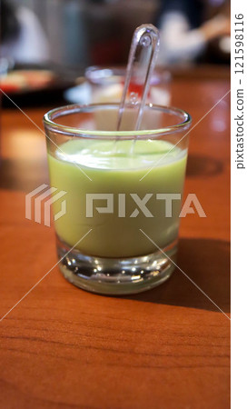 Matcha tea green jelly pudding dessert in a small glass. Matcha tea green jelly pudding dessert in a small glass. 121598116