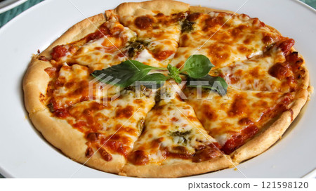 Whole complete Italian pizza Margherita served in a plate. 121598120