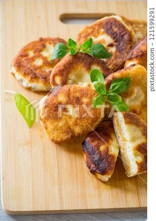 cooked fried pea pies on a wooden board cooked fried pea pies on a wooden board 121599291