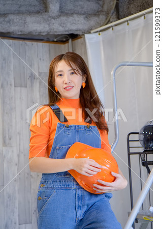Young woman painting a wall Young woman painting a wall 121599373