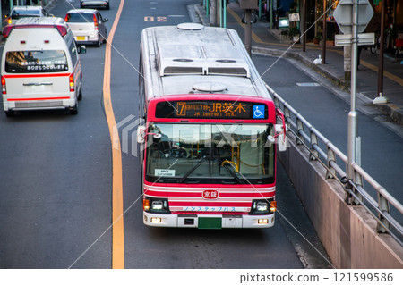 An ambulance passes a Keihan bus near JR Ibaraki Station 121599586