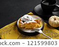 Pumpkin buns yeast bread or cinnabon with spices on plate and cup of tea on black background. Thanksgiving Food Concept. Autumn concept 121599803