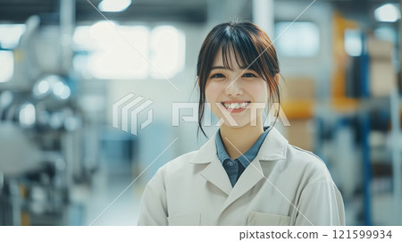 Smiling Asian woman working in a factory 03 121599934