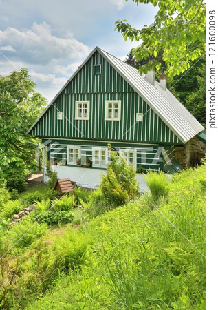 Beautiful wooden cottage during summer Beautiful wooden cottage during summer 121600098