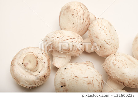 Fresh champignons on a white plate. Mushrooms on a white background. 121600222