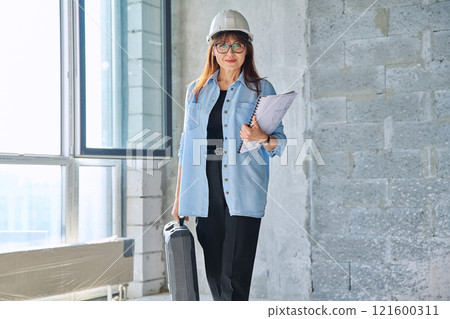 Portrait of female architect decorator of final finishing, repair manager in new house office 121600311