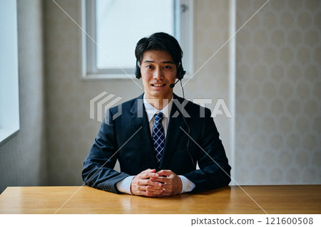 A young man in his twenties wearing a headset A young man in his twenties wearing a headset 121600508