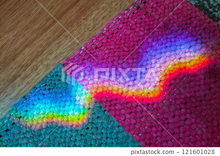 A wavy reflection of the iridescent stratification of sunlight on grandmother's old carpet. Fairy tale atmosphere and nostalgia A wavy reflection of the iridescent stratification of sunlight on grandmother's old carpet. Fairy tale atmosphere and nostalgia 121601028