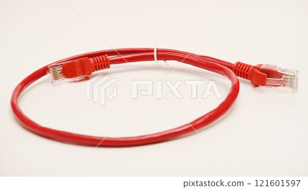 Red internet cable on a white background. The RJ-45 connector. Red internet cable on a white background. The RJ-45 connector. 121601597