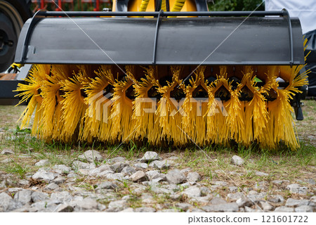 Close-up of industrial street sweeper brush and wheels. 121601722