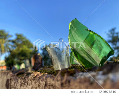 broken glass bottles on the fence to protect private territory from trespassing 121601840