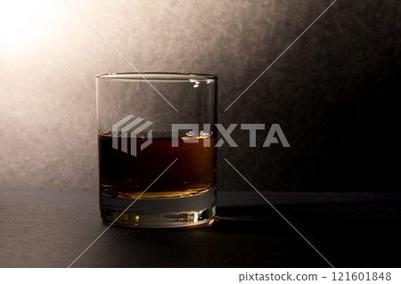 glass goblet with whiskey on a dark background glass goblet with whiskey on a dark background 121601848