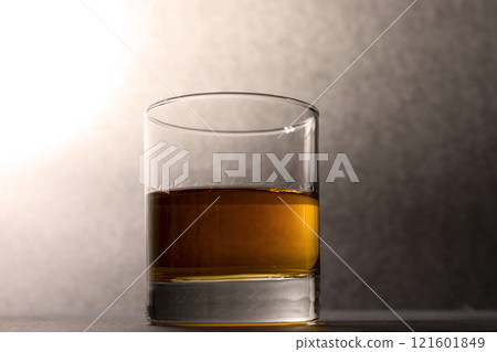 glass goblet with whiskey on a dark background glass goblet with whiskey on a dark background 121601849
