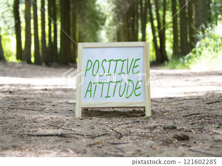 Positive attitude symbol. Concept word Positive attitude on white chalk background. Beautiful forest background. Business and Positive attitude concept. Copy space 121602285