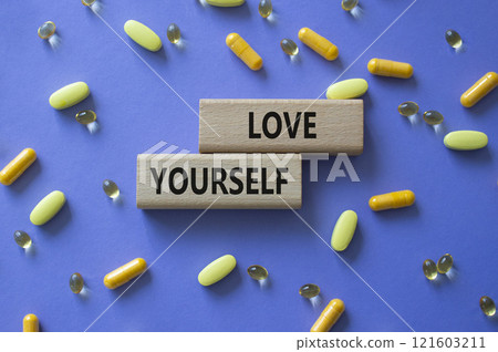 Love Yourself symbol. Concept words Love Yourself on wooden blocks. Beautiful purple background with pills. Mindfulness and Love Yourself concept. Copy space. Love Yourself symbol. Concept words Love Yourself on wooden blocks. Beautiful purple background with pills. Mindfulness and Love Yourself concept. Copy space. 121603211