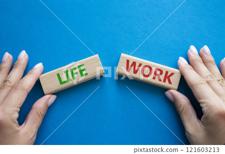 Life or Work symbol. Concept word Life or Work on wooden blocks. Businessman hand. Beautiful blue background. Business and Life or Work concept. Copy space 121603213