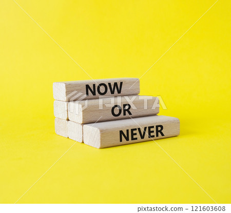 Now or Never symbol. Concept words Now or Never on wooden blocks. Beautiful yellow background. Business and Now or Never concept. Copy space 121603608