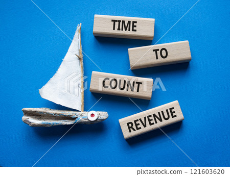 Time to count Revenue symbol. Wooden blocks with words Time to count Revenue. Beautiful blue background with boat. Business and Time to count Revenue concept. Copy space. 121603620