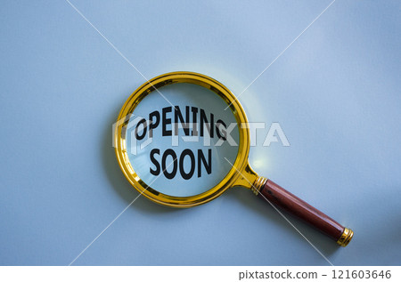 Opening soon symbol. Magnifying Glass with Concept word Opening soon. Beautiful blue background. Business and Opening soon concept. Copy space 121603646