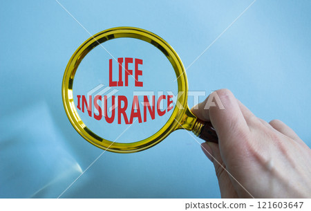 Life insurance symbol. Magnifying glass with words Life insurance. Businessman hand. Beautiful blue background. Business and Life insurance concept. Copy space. 121603647