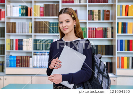 Portrait of smiling teenage girl student, inside high school building Portrait of smiling teenage girl student, inside high school building 121604190